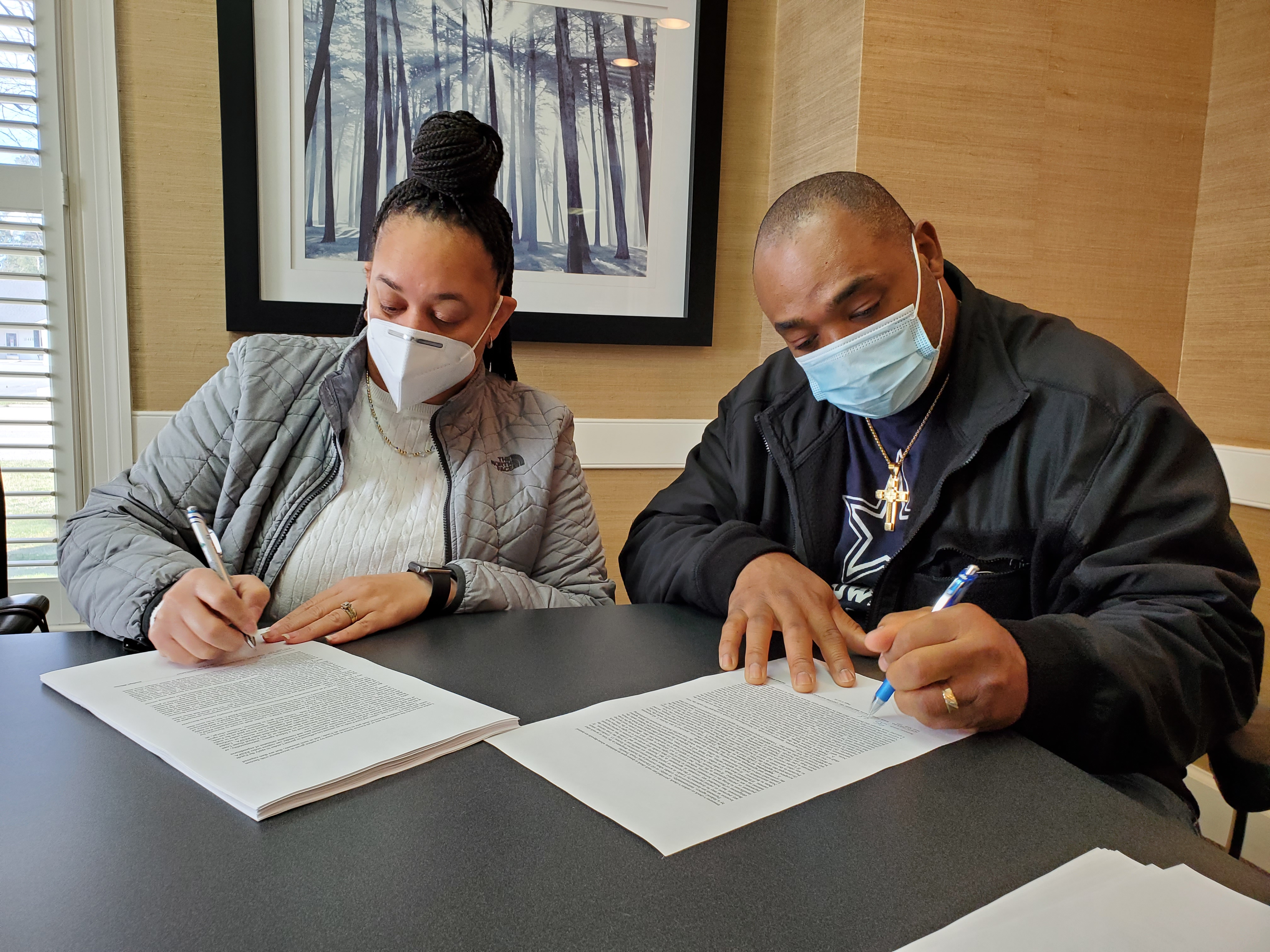 Couple signing at closing